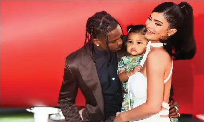  ??  ?? ‘A video snippet of her singing the phrase to her baby daughter went viral.’ Kylie Jenner with former partner Travis Scott and their daughter, Stormi Webster. Photograph: Tommaso Boddi/Getty Images for Netflix