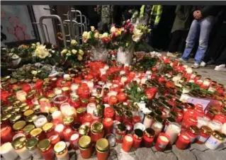  ?? ULI DECK/AFP/GETTY IMAGES ?? Candles and flowers amass outside of a drugstore in Kandel, a sleepy town of barely 10,000 inhabitant­s, where a 15-year-old girl was fatally stabbed by her Afghan ex-boyfriend in December 2017.