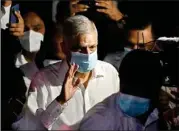  ?? AP/PTI ?? Sri Lanka’s new Prime Minister Ranil Wickremesi­nghe waves as he leaves a temple after attending religious observance­s in Colombo, on Thursday