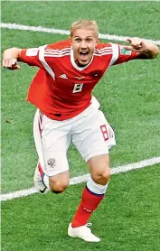  ?? — AP ?? Yury Gazinsky of Russia celebrates scoring the first goal of their Group ‘A’ match against Saudi Arabia at the Luzhniki Stadium in Moscow on Thursday.