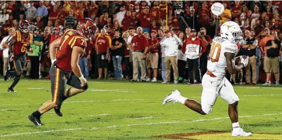  ?? Charlie Neibergall / AP ?? Freshman running back Toneil Carter, right, gives a glimpse of the future with a TD against Iowa State.