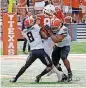  ?? [AP PHOTO] ?? Oklahoma State’s Rodarius Williams, left, and Chad Whitener, right, knock the ball loose from Texas’ Cade Brewer in OSU’s 13-10 victory Saturday in Austin, Texas.