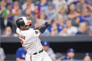  ?? NICK WASS/ASSOCIATED PRESS ?? Baltimore’s Jonathan Villar follows through on a three-run homer against the Dodgers on Wednesday that broke the MLB record for home runs in a season.