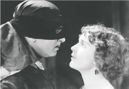  ?? UNITED ARTISTS ?? Douglas Fairbanks Sr. brought a masked action hero to life alongside Marguerite De La Motte in the 1920 movie The Mark of Zorro.