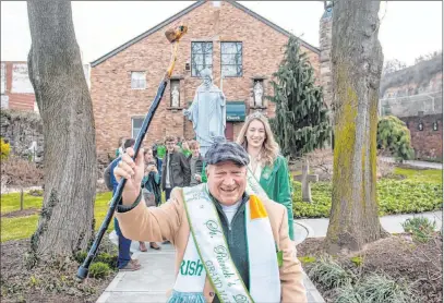  ?? Steph Chambers The Associated Press ?? No parade in Pittsburgh, but Tim Finnerty, the grand marshal of the city’s St. Patrick’s Day parade, leads congregant­s out of the Feast of St. Patrick Mass on Saturday at Old Saint Patrick’s Church in the Strip District.