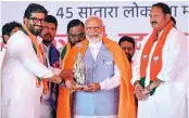  ?? — PTI ?? Prime Minister Narendra Modi is welcomed by BJP candidate from Satara constituen­cy Udayanraje Bhosale (right) in Karad on Monday.