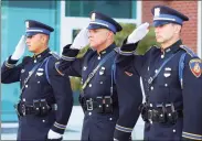  ??  ?? Stamford Police Officers Damein Rosa, left, Lt. Douglas Deiso, and Sgt. Kevin Lynch, right, salute.