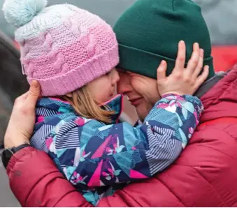  ?? ?? Heart-rending: Dasha, six, holds her father Roman close, asking him not to go