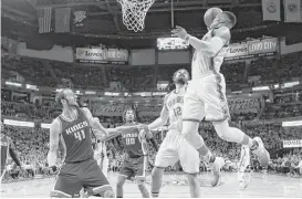  ?? Sue Ogrocki / Associated Press ?? Oklahoma City guard Russell Westbrook, right, had 28 points, eight rebounds and 10 assists to help lead the Thunder to their fifth straight victory.