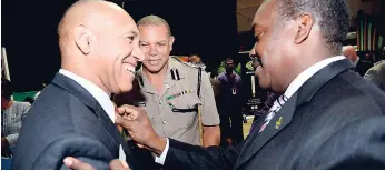  ??  ?? Minister of National Security Robert Montague (right) in discussion with Acting Commission­er of Police Clifford Blake (centre) and incoming Commission­er of Police Major General (ret’d) Antony Anderson at the launch of the JamaicaEye initiative yesterday.