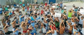  ?? PHOTO: REUTERS ?? Asylum seekers protesting on Manus Island, Papua New Guinea. New Zealand has offered to take 150 detained refugees.