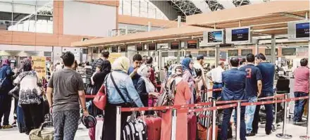  ?? BLOOMBERG PIC ?? Passengers waiting in line inside the Sabiha Gokcen Internatio­nal Airport in Istanbul, Turkey. Kenanga sees positive developmen­t in Turkey’s tourism, supported by the constituti­onal referendum held throughout the country on April 16.