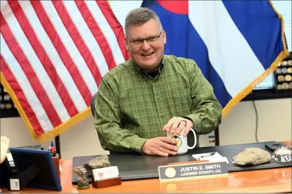  ?? ?? AT LEFT: Larimer County Sheriff Justin Smith reminisces about his time as sheriff and his law enforcemen­t career that led to him becoming sheriff.