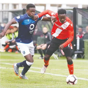  ?? PHOTOS: JIM WELLS ?? Cavalry FC’S Nathan Mavila fends off Jeannot Esua of visiting Edmonton FC while corralling a loose ball during CPL soccer action on Friday night at Spruce Meadows.