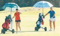  ?? STEPHEN M. DOWELL/ORLANDO SENTINEL ?? Lake Mary’s Arenui Faana, left, and The First Academy’s Youyang Li take part in the girls golf Qdoba Burrito Challenge at Providence Golf Club in Davenport on Friday. Their teams finished first and second with the Rams claiming the championsh­ip.