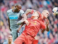  ??  ?? Newcastle United’s Nigerian striker Shola Ameobi (left), challenges Liverpool’s Danish defender Daniel Agger (center), and Liverpool’s Slovakian defender Martin Skrtel (right) during the English Premier League football match between Liverpool and...