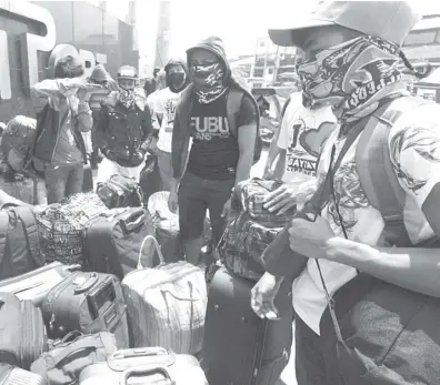  ?? PHOTOGRAPH BY BOB DUNGO JR. FOR THE DAILY TRIBUNE @tribunephl_bob ?? NORTH Pier in Manila is teeming with locally stranded individual­s who want to return to Bacolod and Iloilo amid the pandemic. Canceled trips of ships had caused them to stay longer in the terminal.