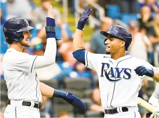  ?? JULIO AGUILAR/GETTY ?? Tampa Bay’s Francisco Mejia, right, celebrates with teammate Josh Lowe after hitting a two-run homer in the third inning against the Baltimore Orioles on Saturday.