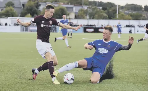  ??  ?? 0 Hearts striker Steven Maclean, left, in action against Cove Rangers on Wednesday, wants to play in every game and on every type of pitch.