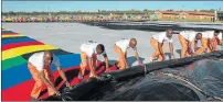  ??  ?? LOVINGLY MADE: Prisoners hard at work helping to create a massive blanket at Zonderwate­r Prison outside Cullinan in honour of the late former president Nelson Mandela’s 100th birthday