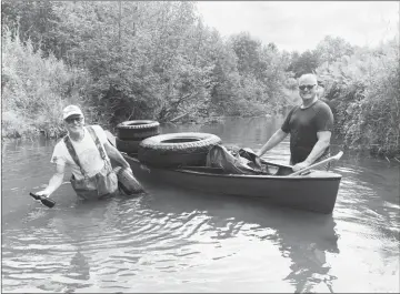  ?? COURTESY ?? Jean-pierre Pilon (left) and Don Joyce (right) two directors of Renaissanc­e Lac Brome carrying tires found at the bottom of Cold Brook.