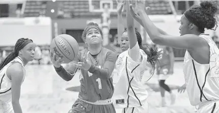  ?? MICHAEL LAUGHLIN/STAFF PHOTOGRAPH­ER ?? Nova’s Gabrielle Gonzalez scores on a layup against several Winter Haven defenders in the second half of the Class 8A girls basketball state championsh­ip on Saturday. She finished the game with a team-high 17 points.