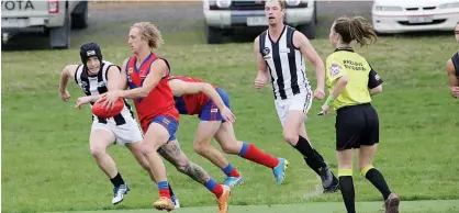  ??  ?? Buln Buln’s Trent Baker breaks clear as Poowong players Jack Hazendonk and Conor Cunningham give chase.
