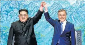  ?? AP FILE ?? North Korean leader Kim Jong Un (left) and South Korean President Moon Jaein raise their hands after signing a joint statement at the border village of Panmunjom on April 27.