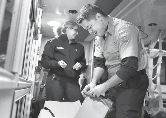  ?? Tribune News Service ?? Talitha Saunders and AJ Ikamoto tidy their ambulance at the end of a recent shift. The two work as emergency medical responders in Oregon with American Medical Response in Portland. Leaders there are working to prevent any race-based disparitie­s in treatment.