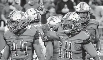  ??  ?? Roughnecks quarterbac­k P.J. Walker reacts to the bench after one of his three touchdown passes to Cam Phillips, this one in the first quarter at TDECU Stadium on Sunday.