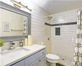  ?? DREAMSTIME ?? It’s important not to go overboard with bathroom upgrades. Keep it simple with a walk-in shower with a rain shower head.