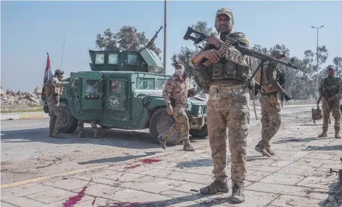  ??  ?? FIGHTING BACK: Iraqi Emergency Response Division (ERD) troops under fire as they advance on the Islamic State. Picture: GETTY IMAGES