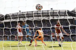  ?? Shaun Botterill / Getty Images ?? Ferran Torres of Manchester City scores his team’s fifth goal past Bernd Leno of Arsenal in a Premier League match at Etihad Stadium in Manchester, England.