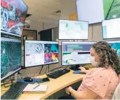  ?? MATIAS J. OCNER mocner@miamiheral­d.com ?? Meteorolog­ist Amanda Reinhart works at the National Hurricane Center on Wednesday in west Miami-Dade.
