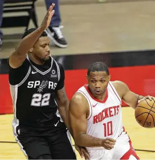  ?? Carmen Mandato / Getty Images ?? Spurs forward Rudy Gay,, defending the Rockets’ Eric Gordon dru9ing a preseason game, said he needs to do more research before endorsing a plan to take the COVID-19 vaccine.