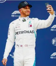  ??  ?? Lewis Hamilton poses for a selfie after taking pole position for the Spanish Grand Prix in Barcelona on Saturday. — AP
