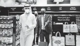  ?? Isabel Debre / Associated Press ?? Officials are shown at Carrefour’s fully automated mini-market in Dubai, United Arab Emirates. It’s the latest addition to the growing field of retail automation.