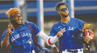  ?? JONATHAN DYER/USA TODAY SPORTS ?? Vladimir Guerrero Jr., Lourdes Gurriel Jr. and the Toronto Blue Jays are forecast to win 87 games this season — but if their young stars perform, the sky's the limit.