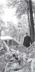  ?? THE ASSOCIATED PRESS ?? Tom Virgili surveys damage from broken limbs of pine trees after a heavy snow fall in Kennesaw, Ga. The frigid temperatur­es behind a cold front combined with moisture off the Gulf of Mexico to bring unusual wintry weather to parts of the South.