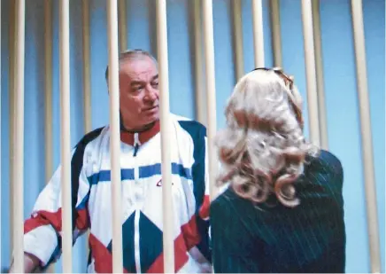  ?? PHOTO: AP ?? Sergei Skripal speaks with his lawyer from behind bars, as seen on a monitor outside a military courtroom in Moscow, during his 2006 espionage trial.