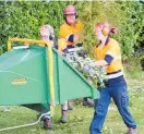  ?? ?? Staff from Recreation­al Services took care of the hedge and the resulting mountain of clipping at Poroutawha­o School’s working bee.