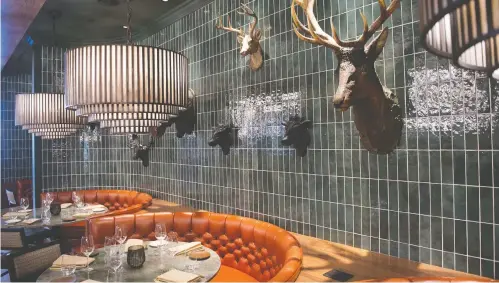  ?? PHOTOS: SHAUGHN BUTTS ?? The J.W. Marriott’s “beast” Braven features leather seating with copper and bronze accents — a nod to classic 1970s steak and seafood joints.