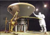  ?? NASA / JPL-CALTECH / LOCKHEED MARTIN ?? A specialist works on NASA’s InSight lander in 2015 ahead of a voyage to Mars. Propelled by a predawn rocket launch from California on Saturday, InSight will study the deep interior of the red planet.