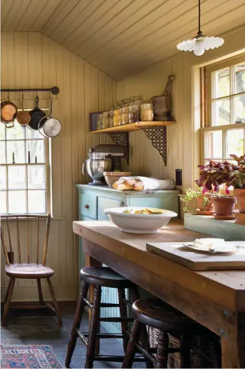  ??  ?? ABOVE The low kitchen ceiling was raised and beadboard added. The painted wood floor was uncovered during renovation. OPPOSITE (clockwise from top) The owner turned the storage room into a butler’s pantry with the addition of a salvaged sink. Some of his large collection of Old Paris vases line the shelf: “They’re often inexpensiv­e and look great grouped together.” • A double sink came from a Brooklyn dealer. • Turn-of-the20th-century cupboards, worktable, and shelves replaced 1950s cabinets.