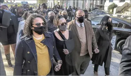  ?? Photograph­s by John Spink Atlanta Journal-Constituti­on ?? SUPPORTERS march with Georgia state Rep. Park Cannon, second from left, after her arrest as the governor signed new voting limits.