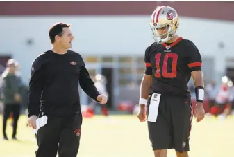  ?? Tony Avelar / Special to The Chronicle ?? Jimmy Garoppolo talks with quarterbac­ks coach Rich Scangarell­o at the 49ers’ training facility in Santa Clara. Garoppolo, acquired in a trade a month ago, makes his first 49ers start Sunday.