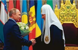  ?? Mikhail Klimentyev / Associated Press ?? Russian President Vladimir Putin, left, is harnessing the resurgent power of the church to promote his agenda. Last month, he celebrated the 70th birthday of Russian Orthodox Patriarch Kirill at Christ the Savior Cathedral in Moscow.