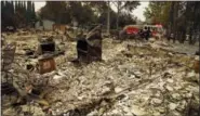  ?? BEN MARGOT — THE ASSOCIATED PRESS ?? Firefighte­rs drive through the Coffey Park area of Santa Rosa looking for hotspots on Tuesday.