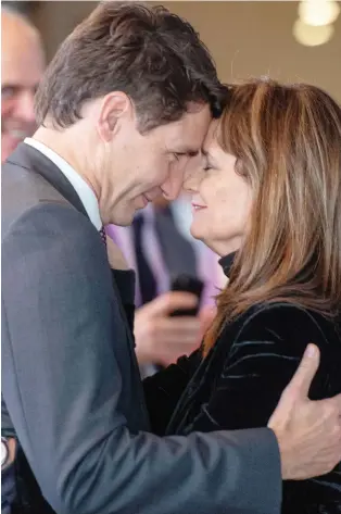  ?? RYAN REMIORZ/ THE CANADIAN PRESS ?? Prime Minister Justin Trudeau shares a moment with Hélène Desmarais, chief executive of the Centre d’entreprise­s et d’innovation de Montréal after her speech at the Element AI conference in Montreal on Thursday.