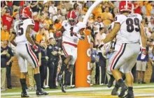  ?? STAFF PHOTO BY C.B. SCHMELTER ?? Georgia wide receiver George Pickens (1) celebrates his 7-yard touchdown catch on a pass thrown by Jake Fromm during the second quarter of Saturday night’s game at Tennessee.